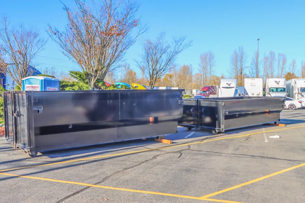 Professional dumpster rental service with roll-off container on residential driveway in Ferguson